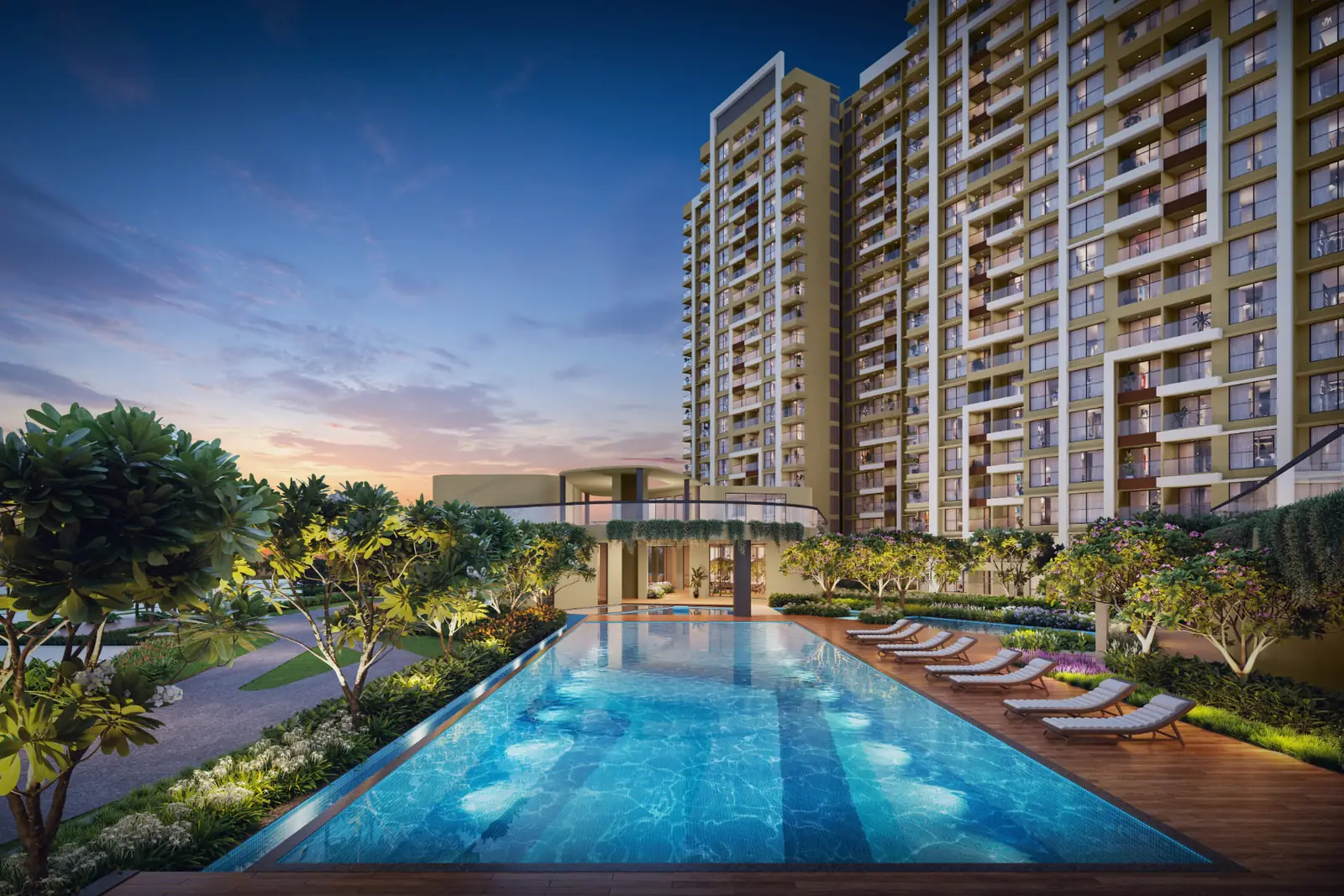 Vyomora towers at dusk beside the landscaped swimming pool deck